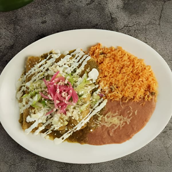 El Patron's enchiladas with green sauce, rice, and refried beans, topped with cheese and pickled onions.