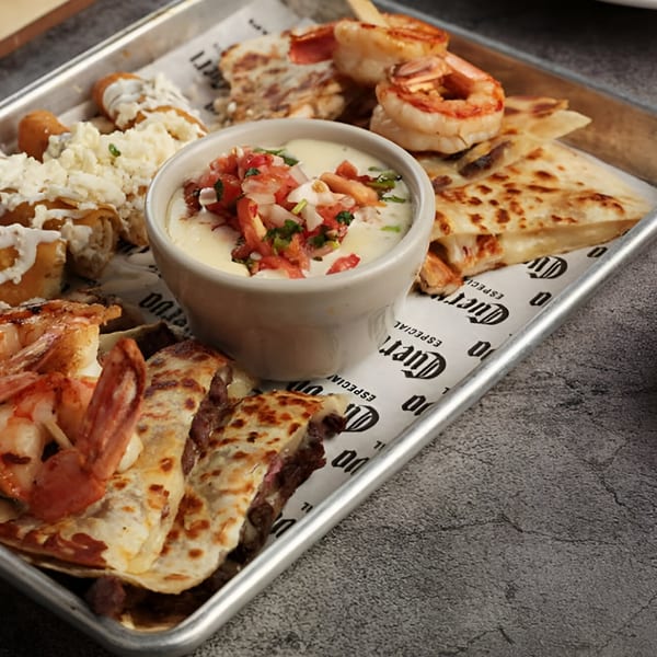 El Patron Mexican Grill & Cantina's appetizer platter with quesadillas, taquitos, shrimp, and a cheese dip.